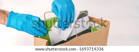 Coronavirus Wiping Down Grocery Packages After Receiving Home Delivery Wearing Gloves Using Disinfe Zdjęcia stock © Maridav