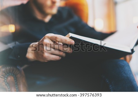 Stock fotó: Adult Man In Glasses Sitting At Chair And Reading Book Leisure Time During Quarantine Isolation