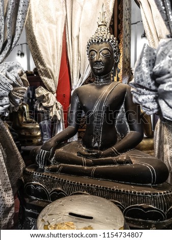 [[stock_photo]]: Stone Sculpture Of Meditating Buddha With Offerings Nepal Kathmandu