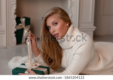 [[stock_photo]]: Beautiful Blond Woman Near The Fireplace In A Luxury Interior