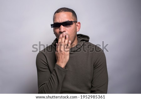 Stockfoto: Bored Casual Man With Glasses Yawns Holding Hand Up