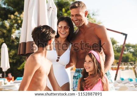 Zdjęcia stock: Image Of Vacation Family With Children Resting Near Luxury Swimm