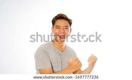 Stok fotoğraf: Emotional Excited Young Asian Man Standing Isolated Over Yellow Background Listening Music With Head