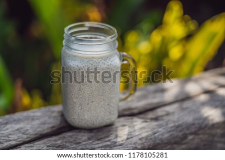 Stock fotó: Healthy Layered Dessert With Chia Pudding In A Mason Jar On Rustic Background