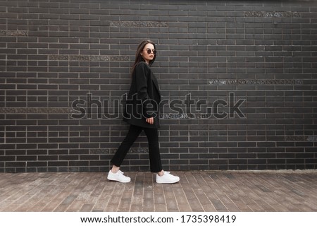 Beautiful Girl Walks In The City Near The Black Wall In The Rain Stok fotoğraf © Alones