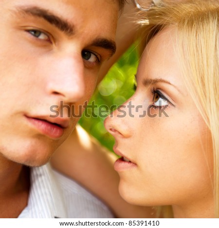 Foto stock: Portrait Of Beautiful Young Couple Standing Against Green Tree I