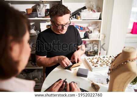 Stok fotoğraf: Craftswoman And Craftsman Working Together In Their Workshop