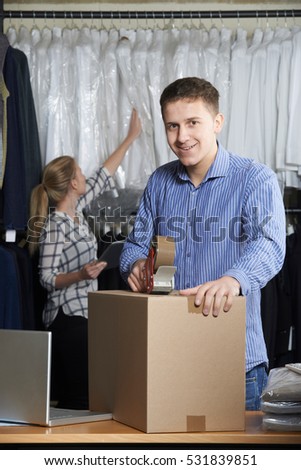 Foto d'archivio: Couple Running Online Clothing Store Packing Goods For Dispatch