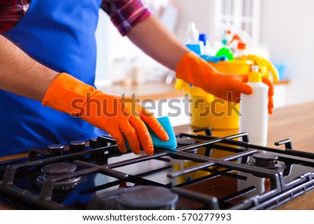 Stock photo: Man Makes Cleaning The Kitchen Young Man Washes An Oven Cleani