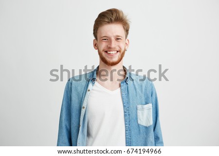 ストックフォト: Portrait Of Young Bearded Hipster Guy Smiling On Gray Background Close Up Brutal Man Lifestyle Rea