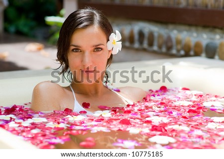Stock photo: Attractive Young Woman In Bath With Petals Of Tropical Flowers And Aroma Oils Spa Treatments For Sk