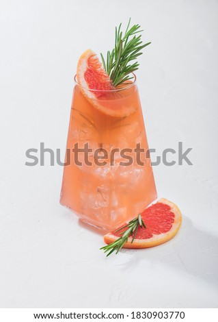 Stockfoto: Summer Red Grapefruit Cocktail In Modern Luxury Highball Glass With Fruit Slice And Rosemary On Whit