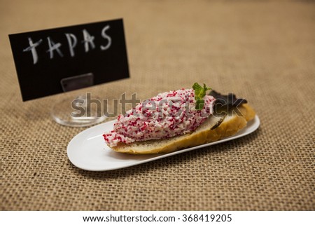 Stockfoto: Tapas Poster Fresh Delicious Spanish Tapas With Tartar Of Herring And Onions On A Black Baguette