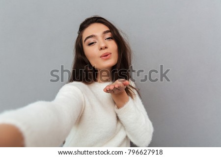 Foto stock: Young Beautiful Smiling Woman In White Soft Sweater Taking Selfi