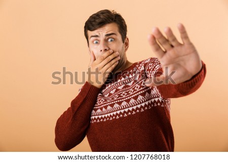 ストックフォト: Image Of Shocked Man 20s With Stubble Wearing Knitted Sweater Do