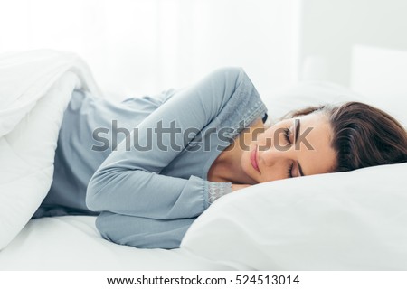 Foto stock: Young Beautiful Woman Sleeping In Her Bed And Relaxing In The Morning