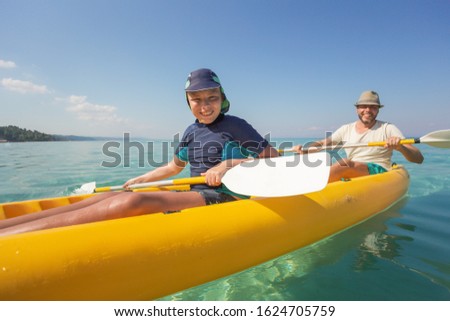 Stockfoto: Summer Vacation Portrait Of Happy Cute Boy Kayaking The On River