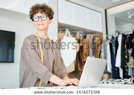Young Female Typing On Laptop Keypad While Thinking Of New Creative Ideas Foto stock © Pressmaster