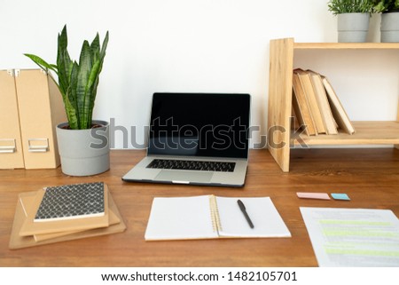 Stock fotó: Wooden Shelf With Books Open Copybook With Pen Laptop And Stack Of Notepads