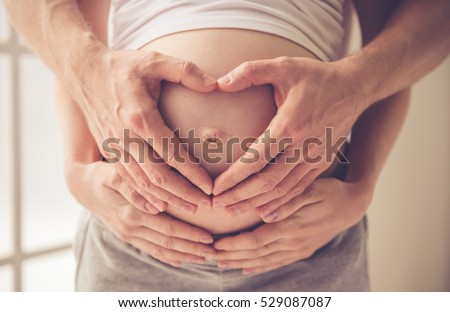 ストックフォト: Cropped Image Of Beautiful Pregnant Woman And Her Handsome Husband Hugging The Tummy