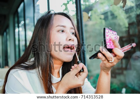 Foto stock: Woman Paints Lips