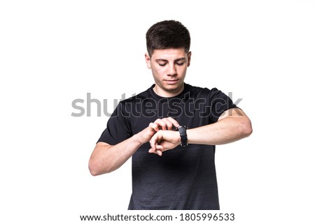 Stock photo: Portrait Of A Focused Young Sportsman Adjusting His Wristwatch