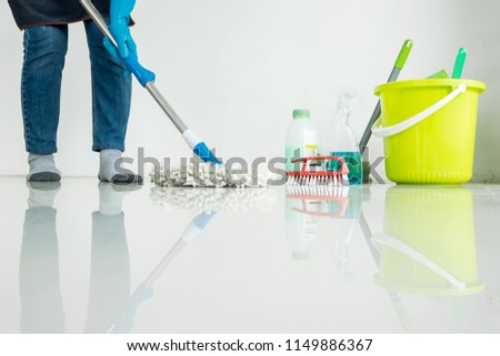 Stock photo: Young Housekeeper Cleaning Floor Mobbing Holding Mop And Plastic
