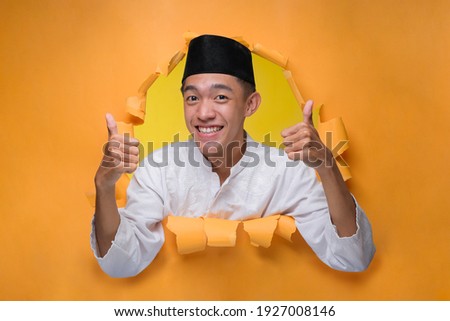 Сток-фото: Young Asian Man Is Smile And Happy When Looking On Paper Document Indonesian Man Wearing Blue Shirt