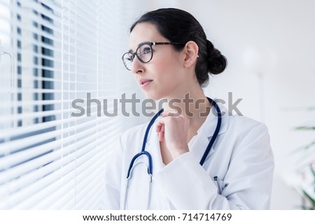 Young Female Doctor Daydreaming While Looking Through The Window Foto d'archivio © Kzenon