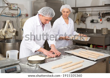 Foto stock: Man Forming The Dough On A Floured Surface And Kneading It With His Hands