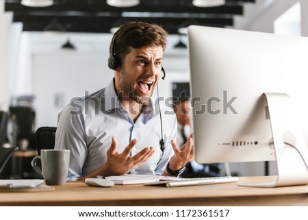 Foto stock: Displeased Office Manager Screaming By Headset With Microphone