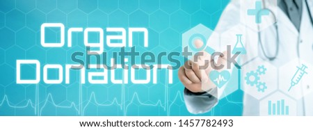 Stockfoto: Doctor Touching An Icon On A Futuristic Interface - Organ Donati