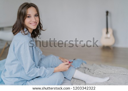 Zdjęcia stock: Charming Cheerful Smiling Woman Musician In Casual Clothes White Socks Feels Relaxed Listens Radi