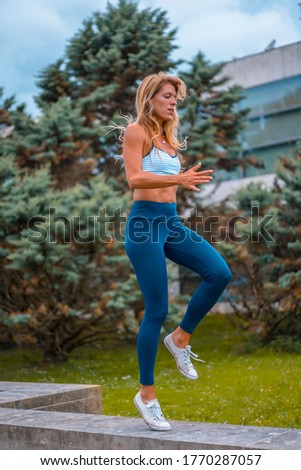 Stock fotó: Attractive Young Sportswoman In Tracksuit Measuring The Waist