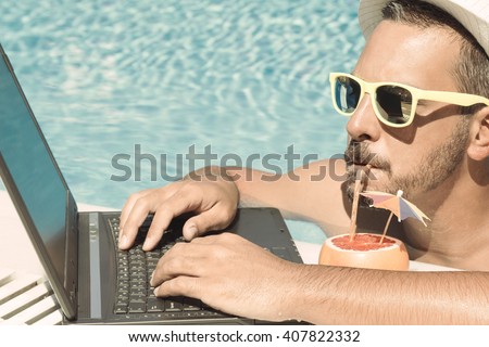 Stockfoto: Young Freelancer Working On Vacation Next To The Swimming Pool