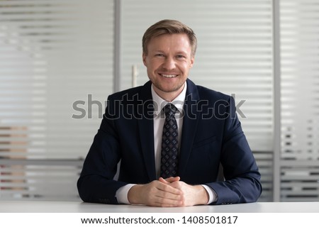 Stock fotó: Smiling Businessman Sitting At Desk