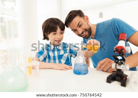 Foto d'archivio: Father And Son Conduct Chemical Experiments At Home Home Made Slime Family Plays With A Slime