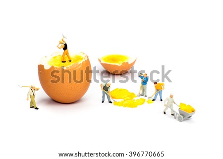 Stok fotoğraf: Team Of Miniature Human Figurines Transporting Chicken Egg Yolk