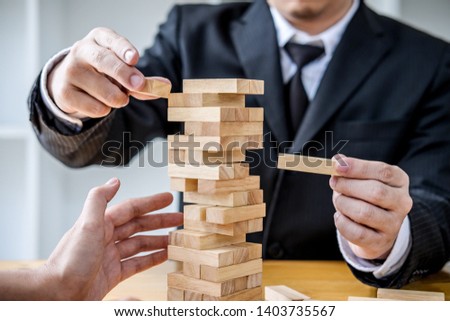 Stock photo: Images Of Hand Of Businesspeople Placing And Pulling Wood Block