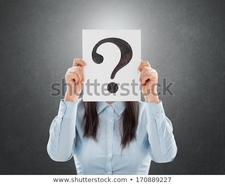 Stock photo: Young Woman Holding Interrogation Symbol In Front Of Her Face