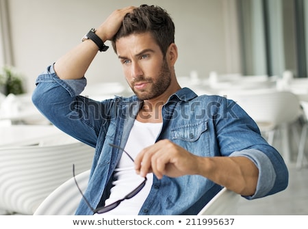 Foto stock: Young Man Touching His Long Beard