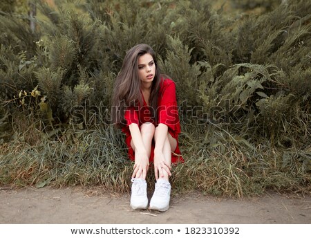 Сток-фото: Seated Elegant Woman In Red Dress Looking To Side