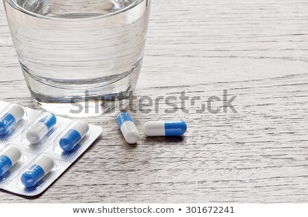 Stock photo: Glass Of Water And Medicine Pills On Wooden Background