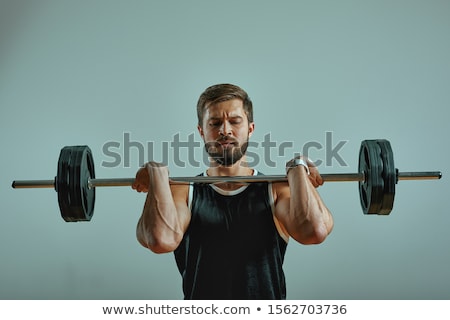 Stockfoto: Portrait Of Super Fit Muscular Young Man Working Out In Gym