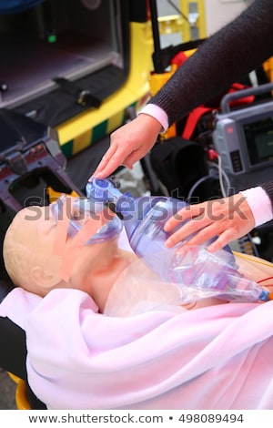 Foto stock: Practicing To Use An Oxygen Mask On Training Doll