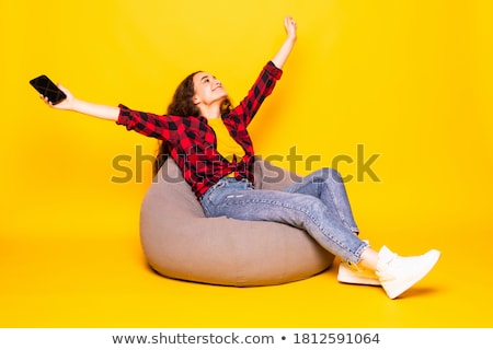 Foto stock: Pretty Girl Sitting And Looking At The Camera