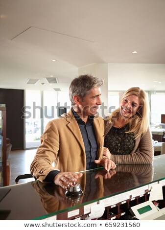 Foto d'archivio: Senior Couple Ringing The Reception Bell In A Hotel