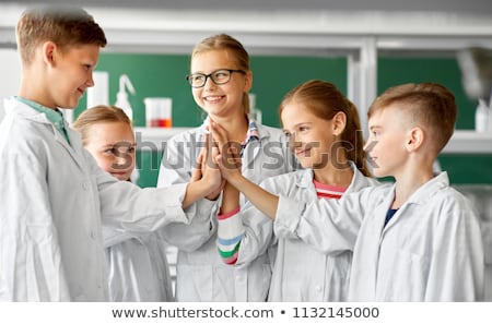 [[stock_photo]]: Happy Kids Making High Five At School Laboratory