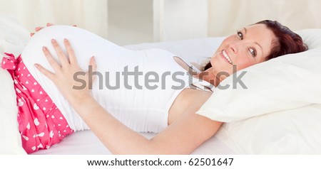 Foto stock: Radiant Pregnant Woman Resting N Her Bed In The Bedroom At Home