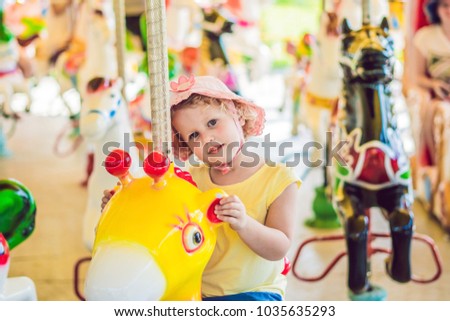 Stock fotó: Cute Little Boy Enjoying In Funfair And Riding On Colorful Carousel House